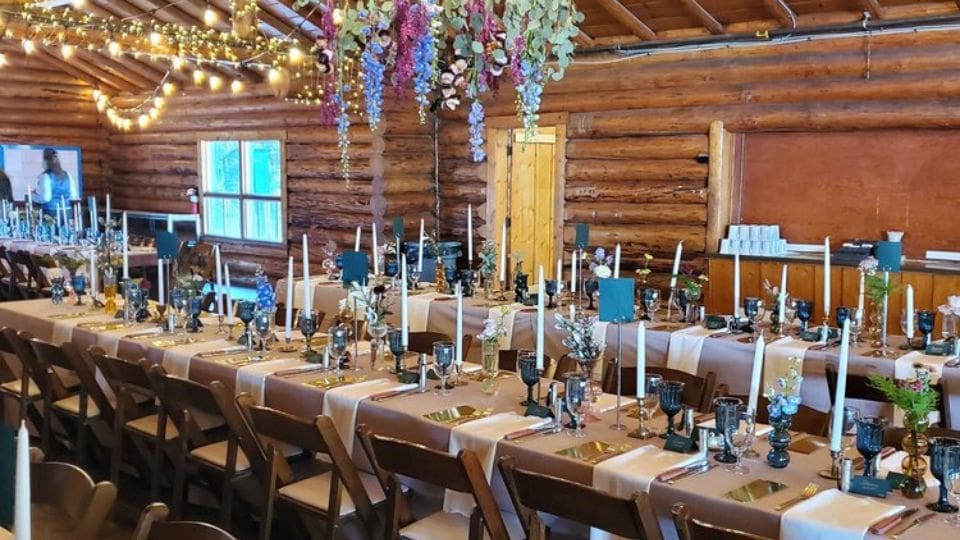 Camp Maskepetoon long table set up for a wedding